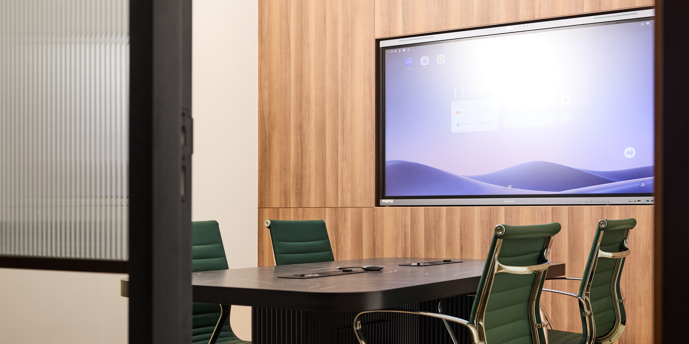 A meeting room at flowork Vision Tower with a smart-screen display