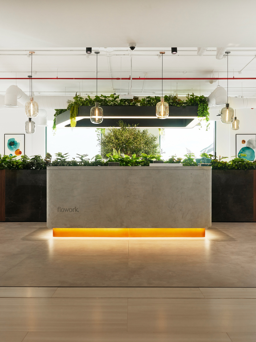 The reception desk at flowork Dubai Hills, lit from beneath