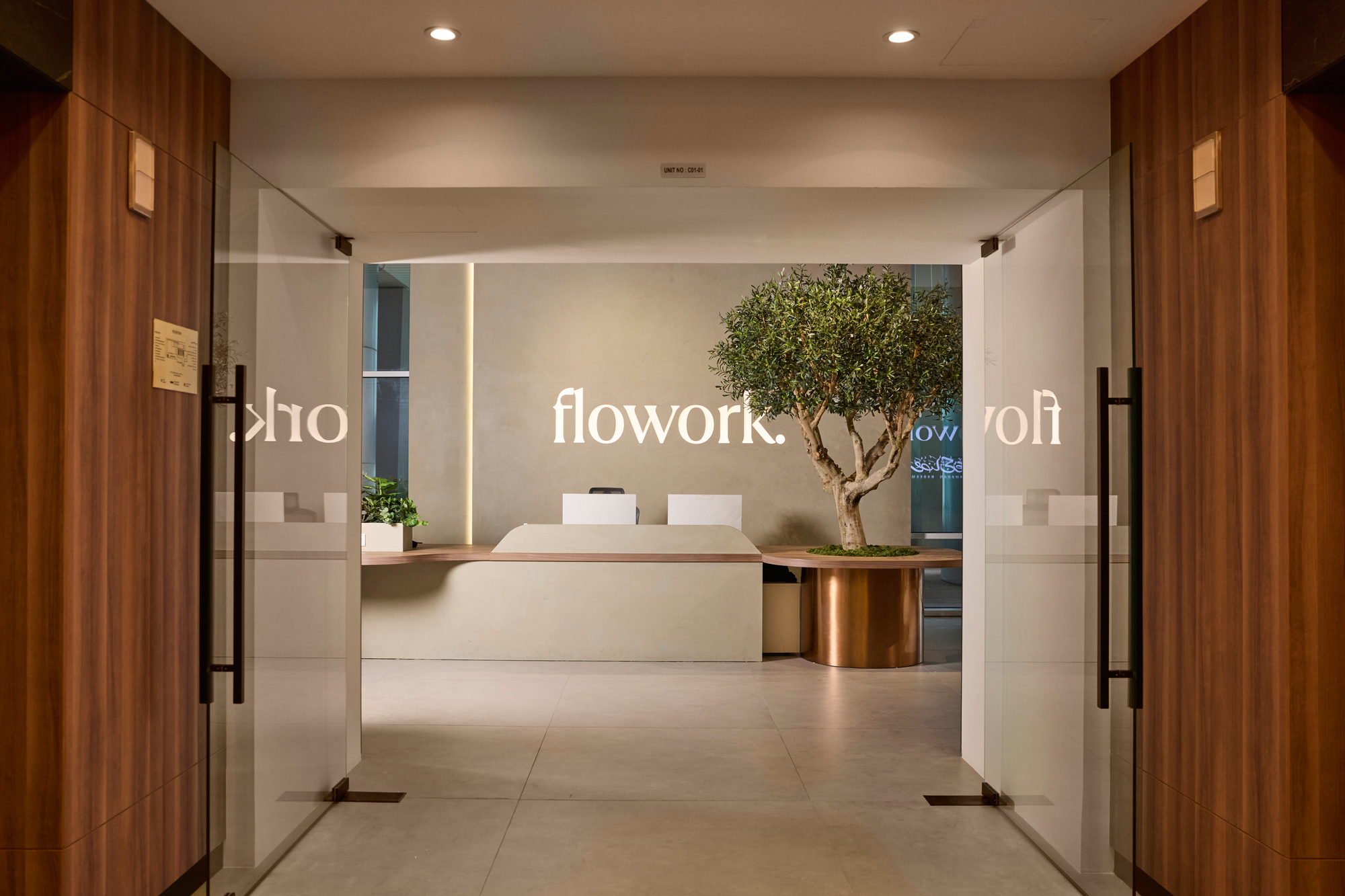 The flowork reception at Vision Tower, through the glass entrance doors