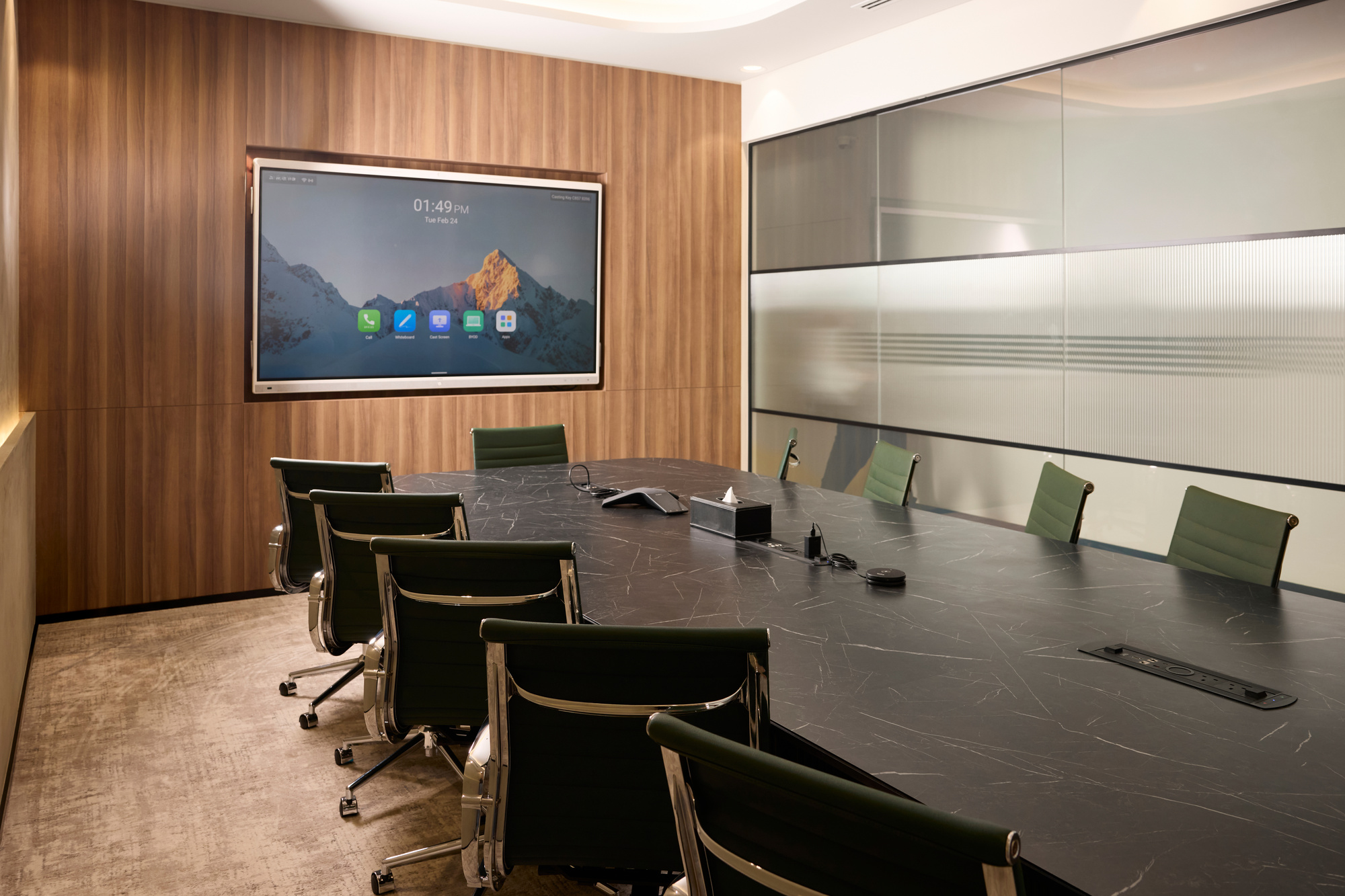 The boardroom at Vision Tower, marble table and green leather chairs