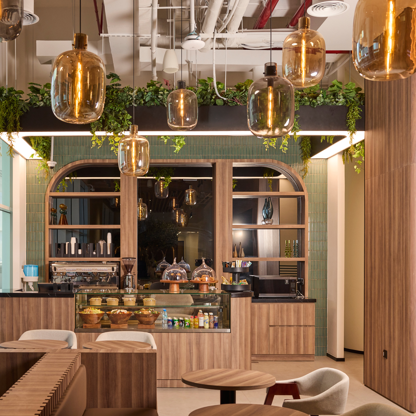 The café counter at Vision Tower, beneath amber glass pendants