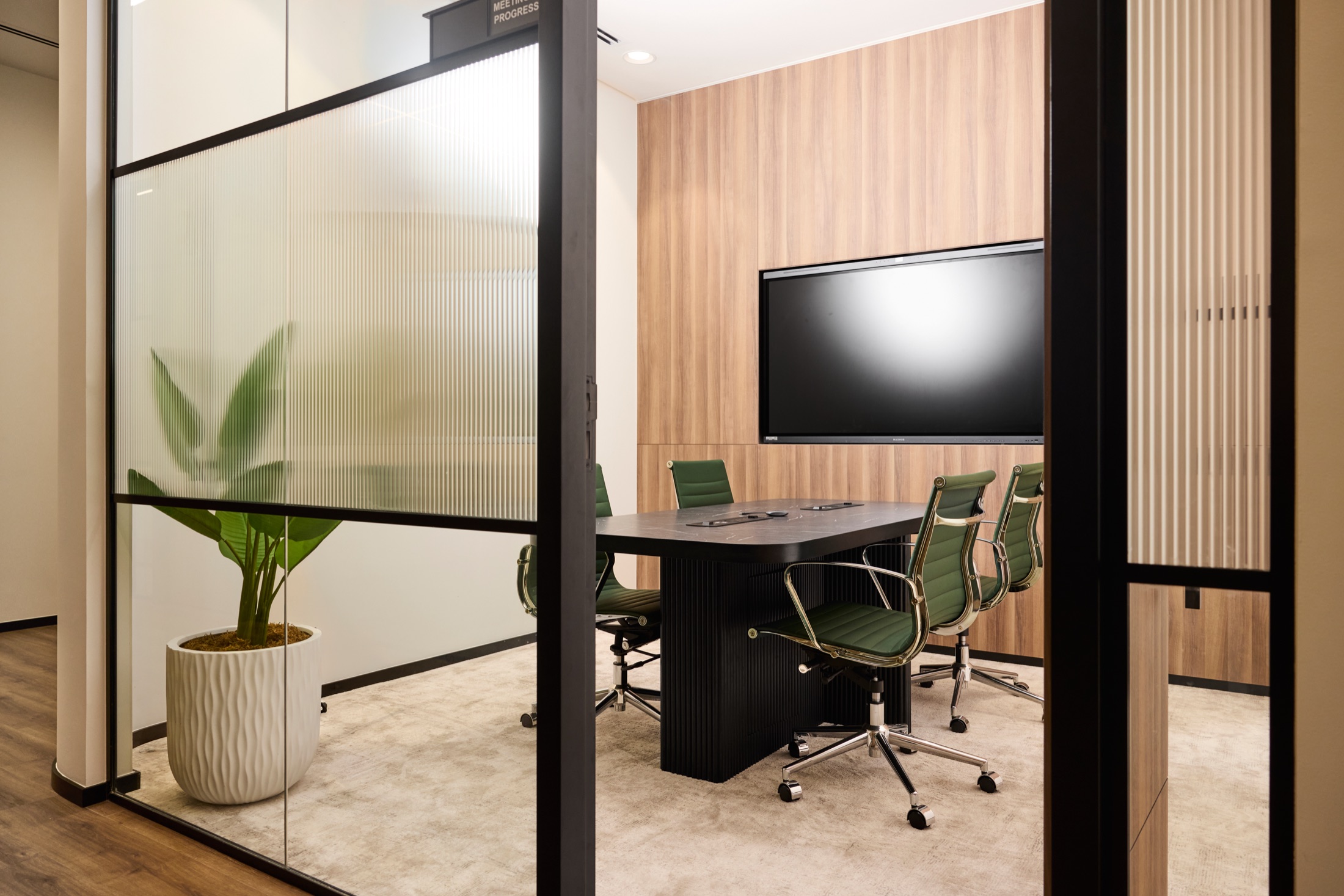 A meeting room at flowork Vision Tower, seen through the glass partition