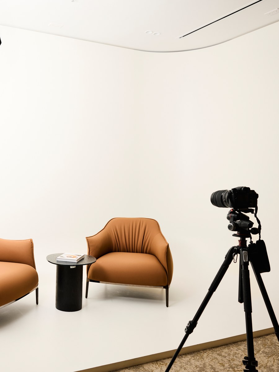 The podcast studio's white backdrop at flowork Vision Tower, camera on a tripod